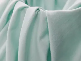 Soft pastel green double yarn fabric with plush drape