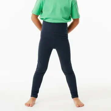 Smiling young girl wearing navy blue high waist leggings with a green t-shirt, highlighting RYZEAL as a kid's high waist leggings manufacturer in Bangladesh.