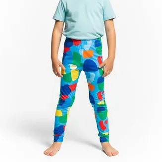Child wearing colorful printed leggings and a light blue t-shirt, representing RYZEAL as a children’s leggings manufacturer in Bangladesh.