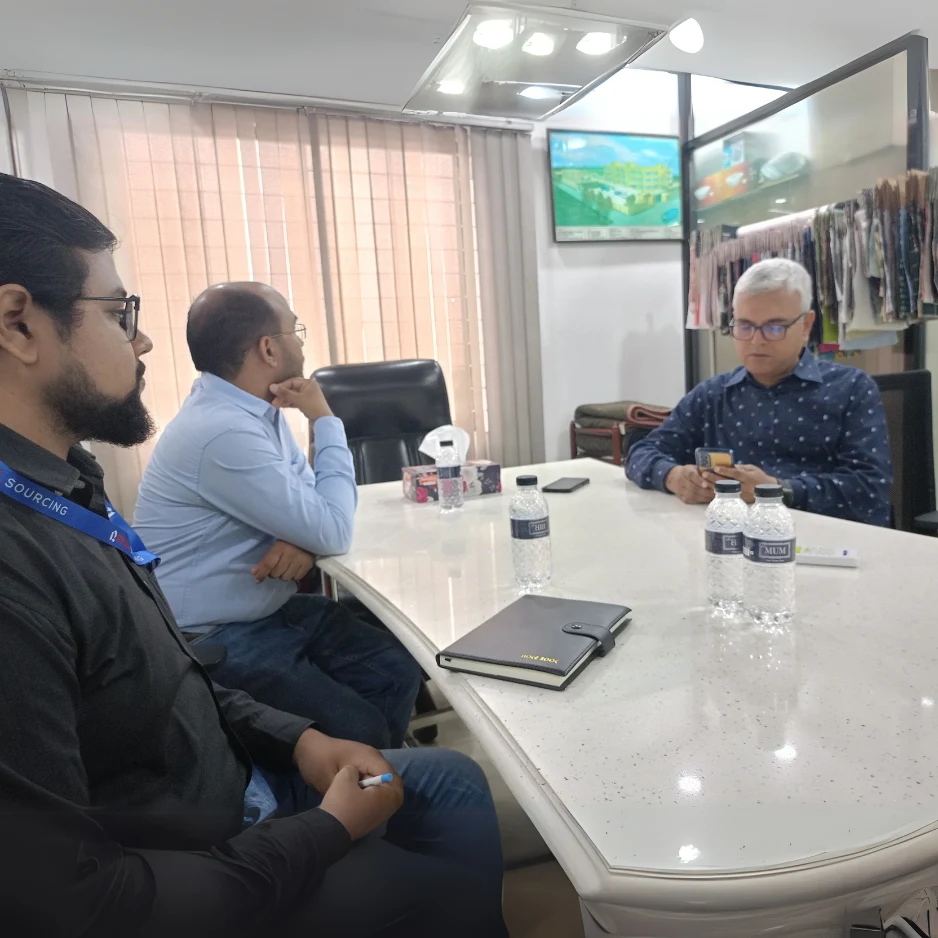 RYZEAL SOURCING team meeting during a factory visit with members discussing production and quality.