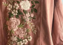3D satin stitch embroidery technique for raised, glossy detailing.