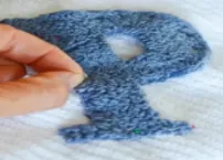 Towel embroidery technique using thick looped threads for a terry-like effect.