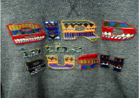 Appliqué embroidery combining stitched fabric pieces for raised designs.