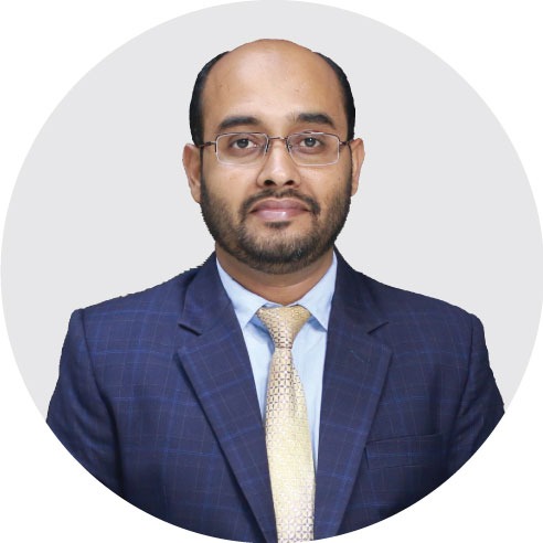 Portrait of a senior executive from RYZEAL Sourcing wearing a formal suit, representing leadership at a leading apparel manufacturing and sourcing company in Bangladesh.