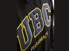Applique technique combining fabric layers for elevated garment branding.